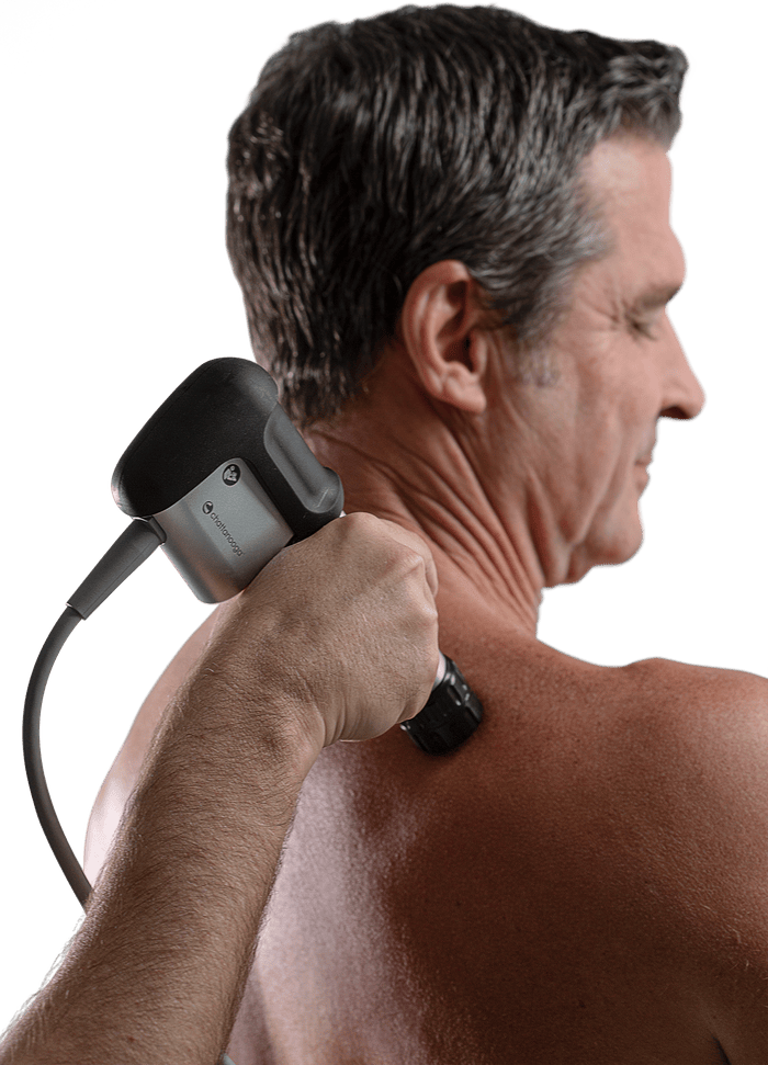 The Chattanooga Mobile RPW2 shockwave device being applied to the shoulder and upper back.